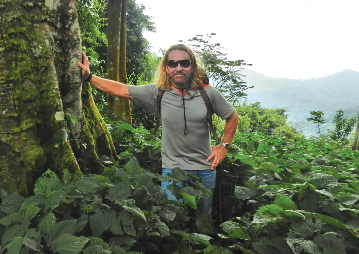 Man walking through a lush forest, connecting the formula to its natural origins